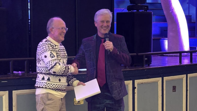 Chris Winchester presents Graham Shelton with a book of memories at the Oxford PharmaGenesis Christmas party in Oxford.